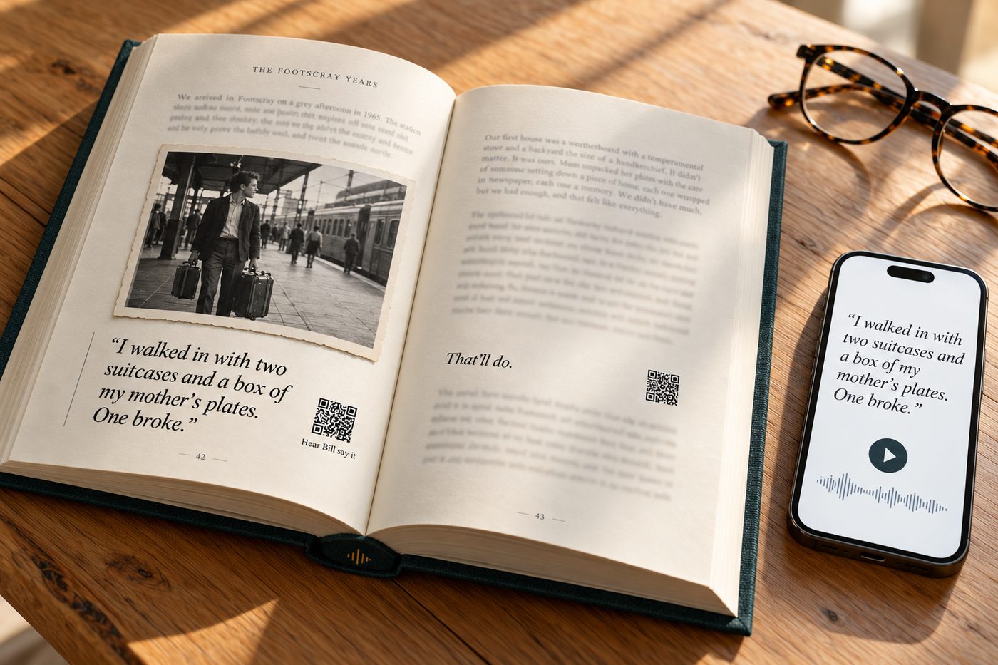 A finished Told hardcover open on a table: a chapter called The Footscray Years, a family photograph, a pulled quote with a small code beside it labelled Hear Bill say it, and a phone showing the same quote with a play button